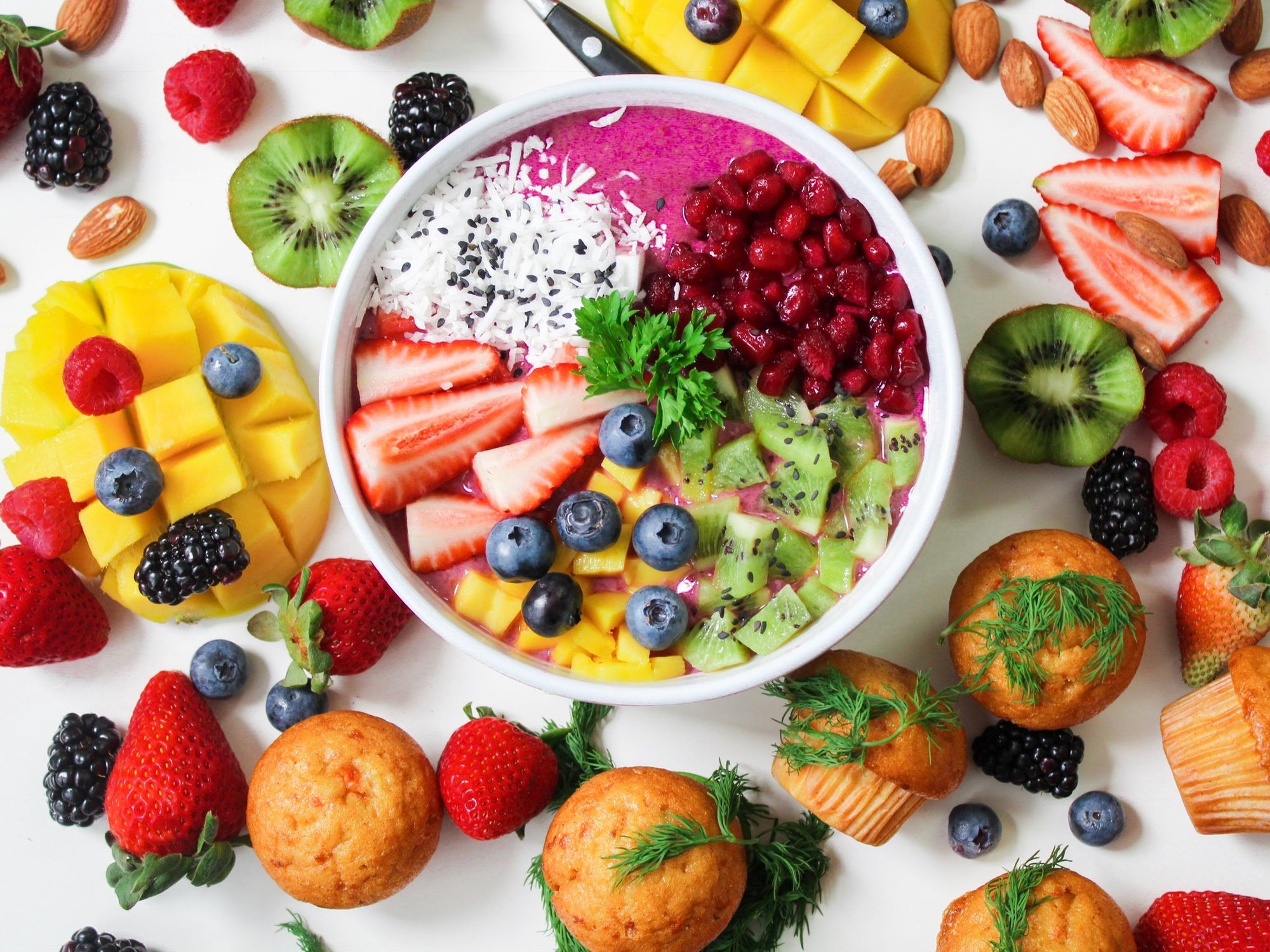 Vibrant smoothie bowl topped with fresh fruit, coconut, and seeds